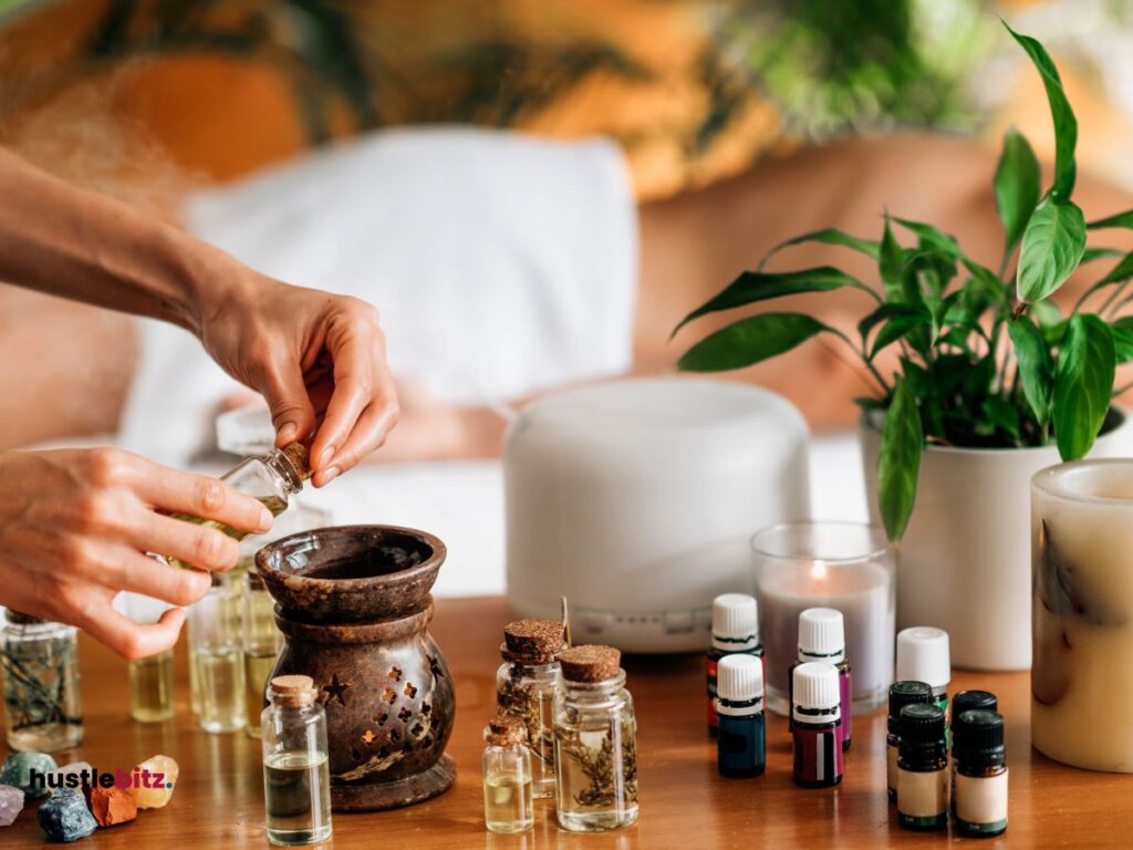 A hand holding an oil and different types of oils in the table