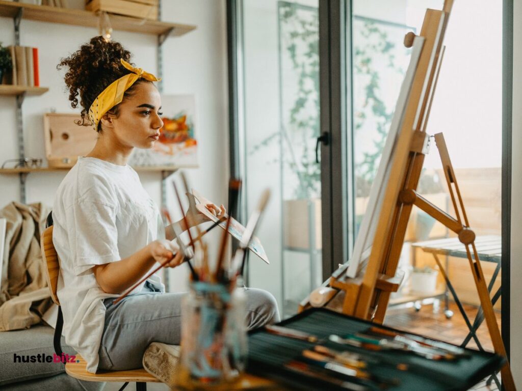 A woman holding a paint brush