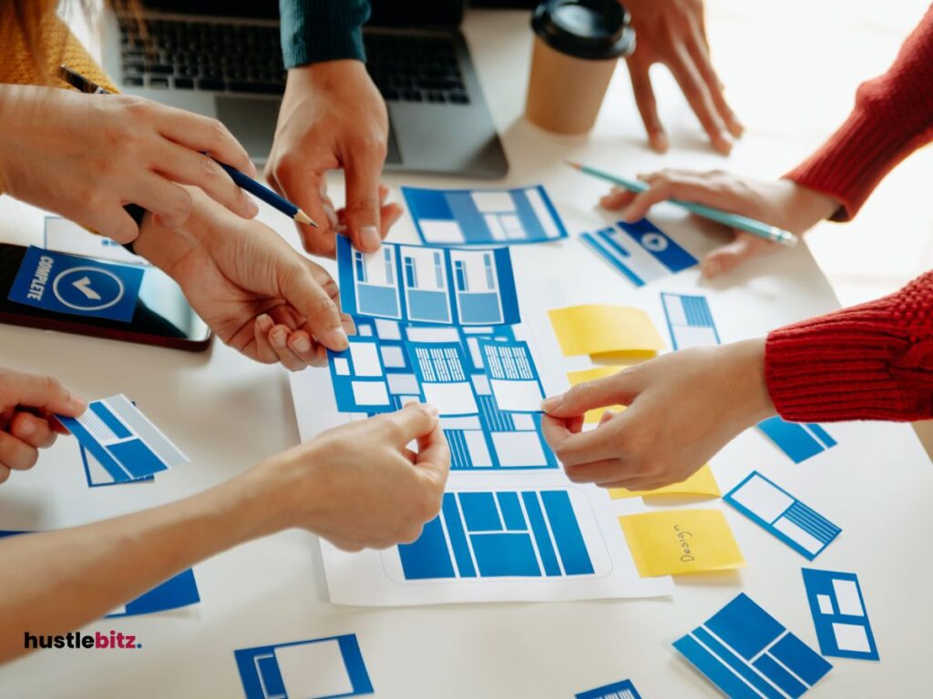 A group of hands holding a pens and other holding a paper plan