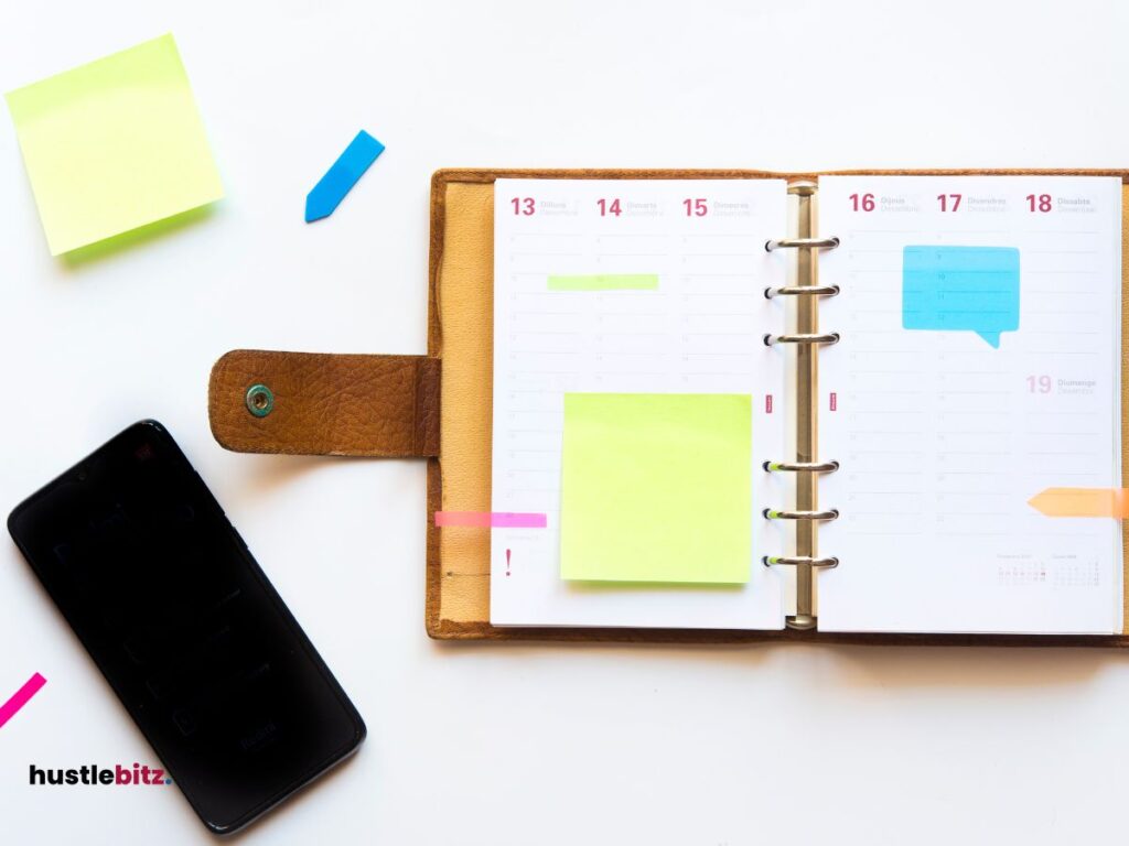 A book with sticky note and a cellphone