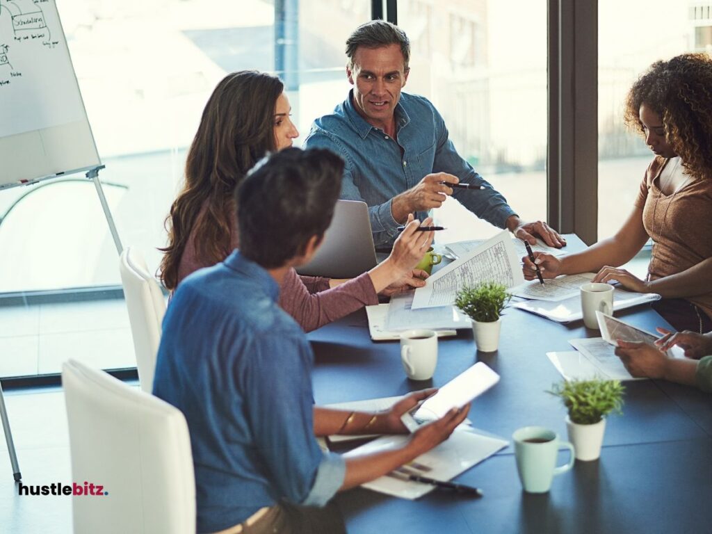 A group of people talking inside the office room