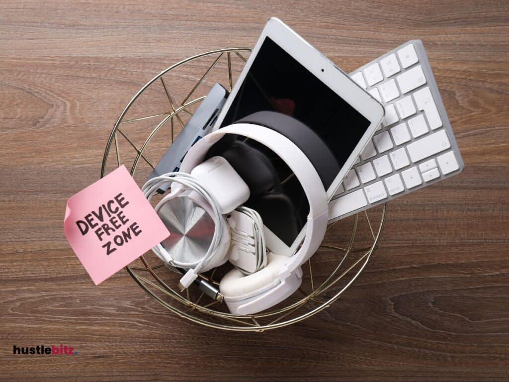 Different gadgets/devices in a basket with a note "Device Free Zone"