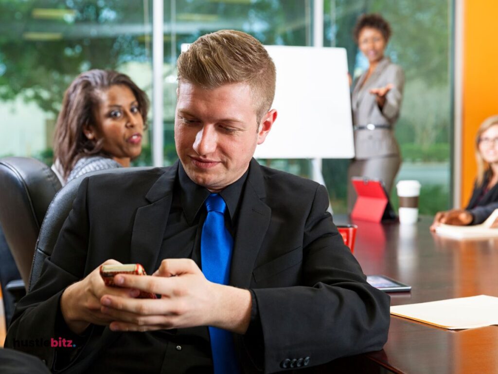 group of people doing meeting and the man using cellphone inside the office