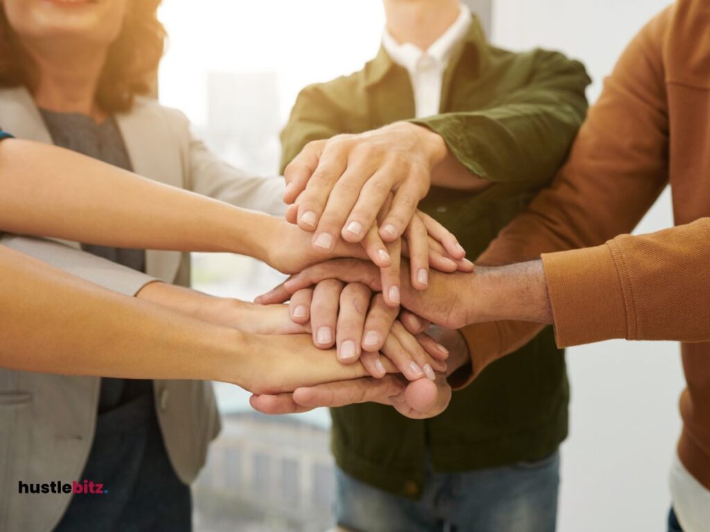 A group of people holding their hands together