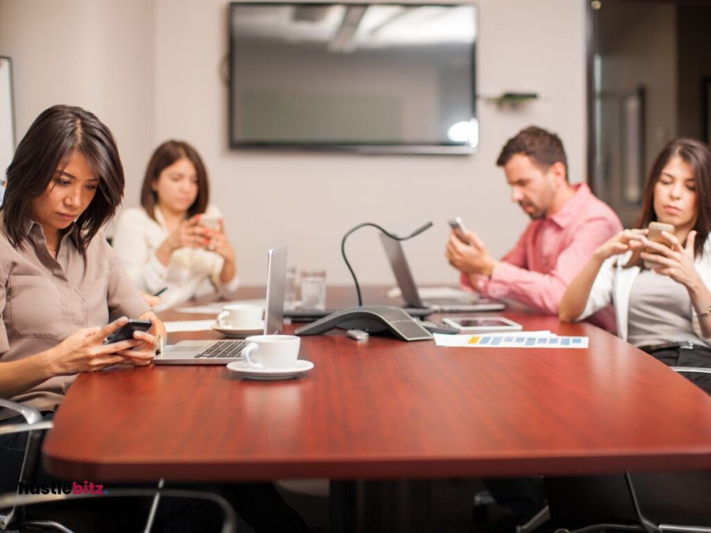 A group of people using cellphone inside the office