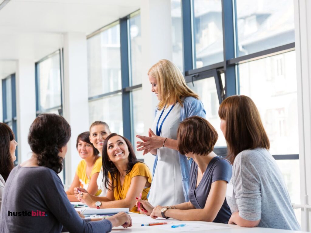 A group of people talking and listening inside the office