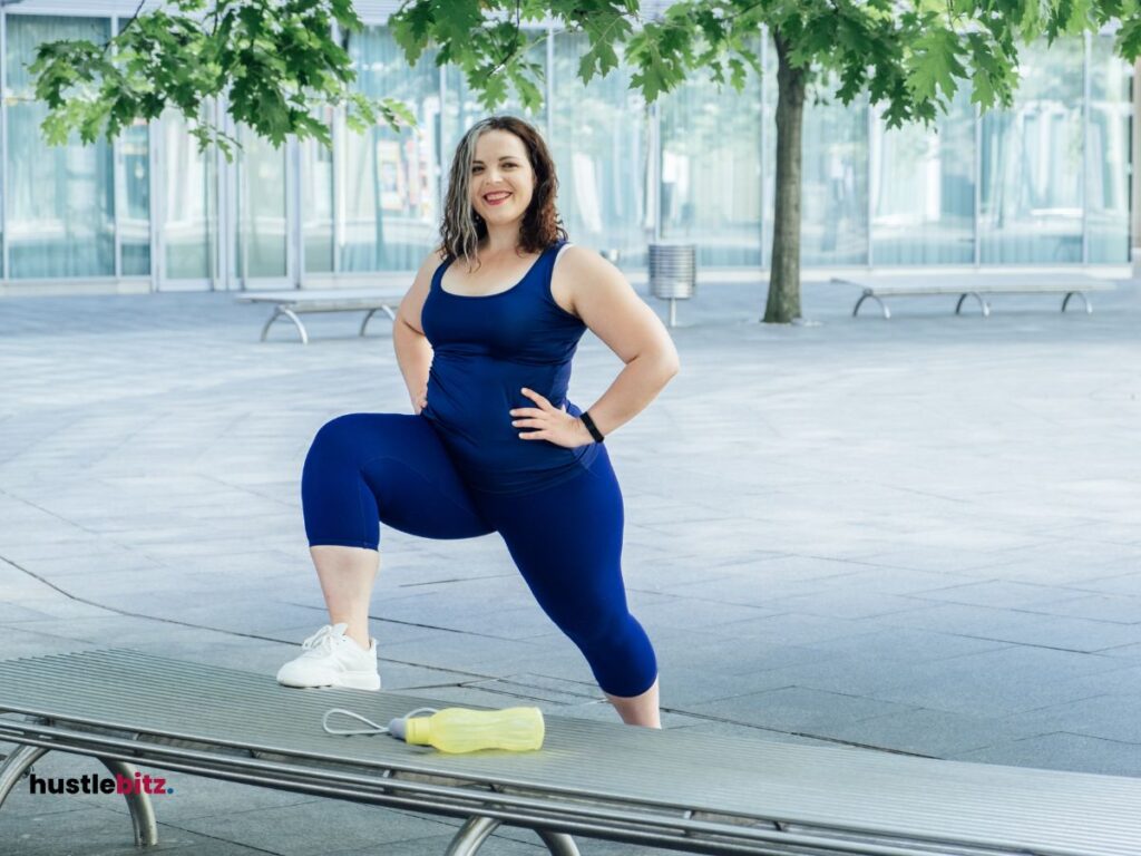 A woman doing exercise smiles at the camera