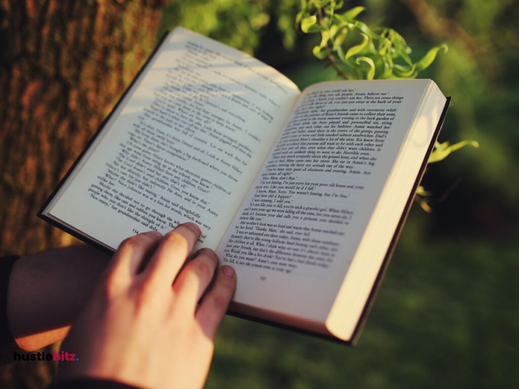 A picture of a hand holding a book and doing reading