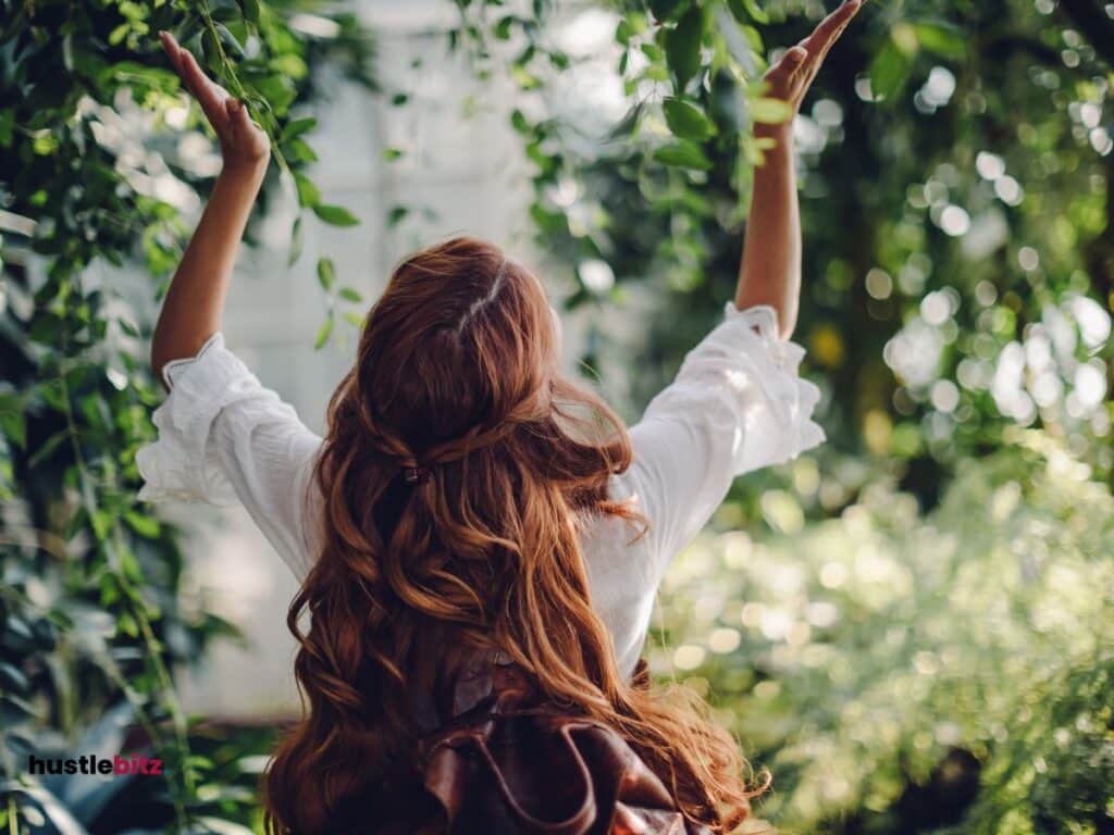 A picture of a woman with trees around.