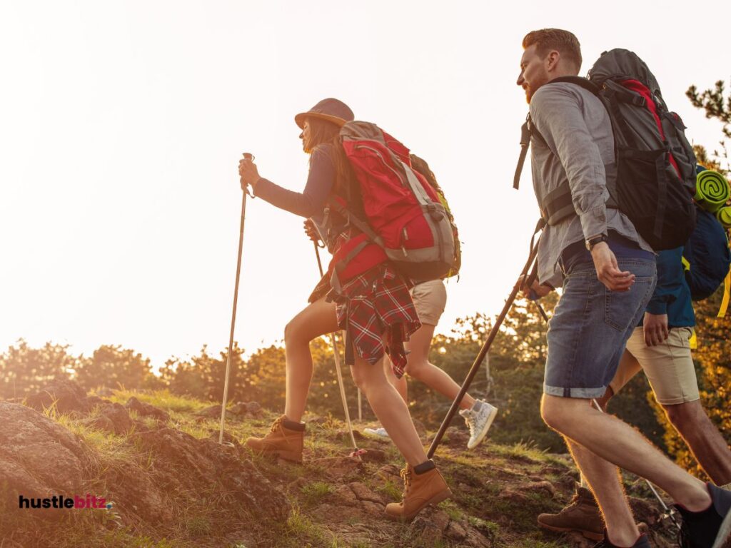 A young man and a group of young women doing hike activities