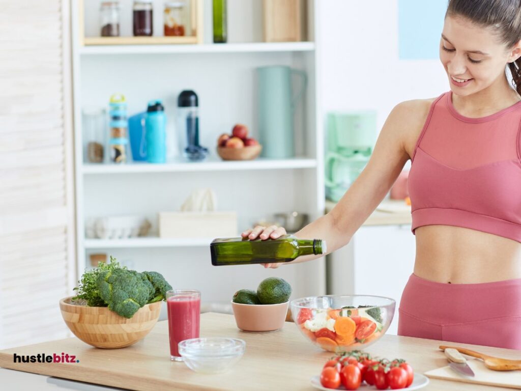 A woman holding a bottle and a fruits and foods in the table