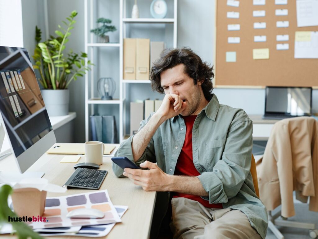 a man using a cellphone inside the office