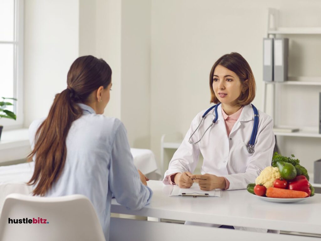 A woman looking at the woman doctor and the fruits in the table