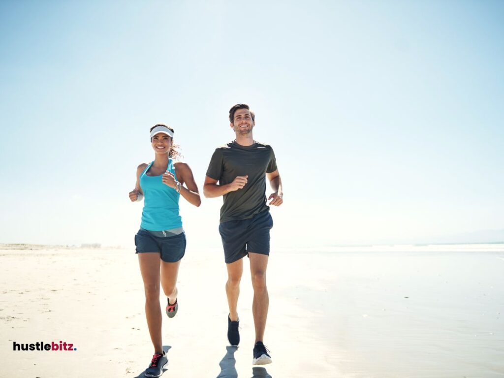 A man and woman doing jogging beside the sea