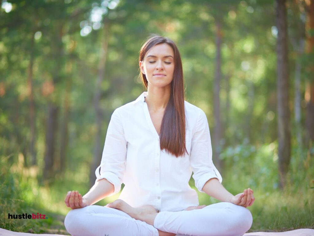 A woman doing meditation and a forest background