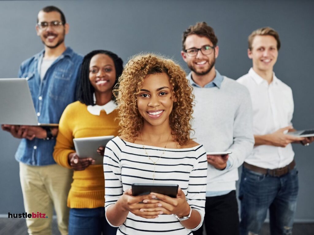 group of people holding a gadget and smiles