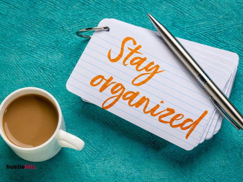 A picture of a coffee a paper with a word " stay organize" and a pen