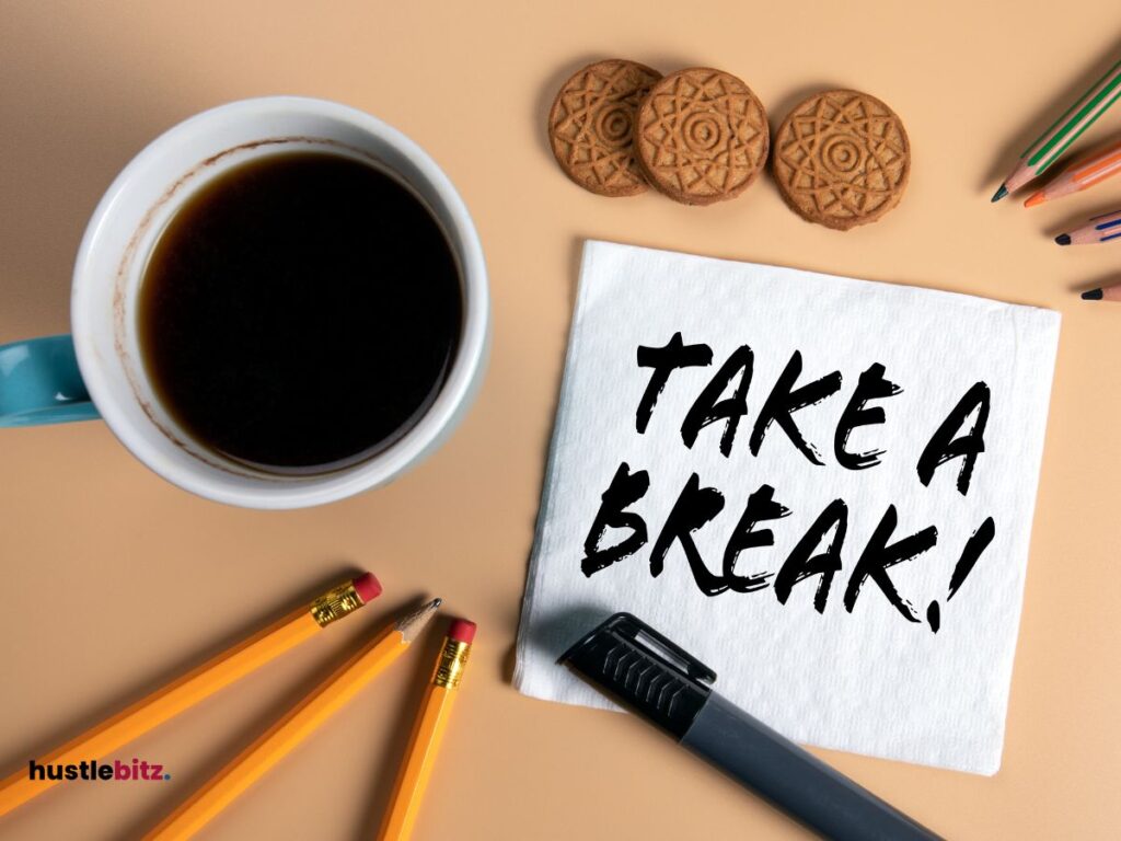 A picture of table with cup of coffee and a pencil