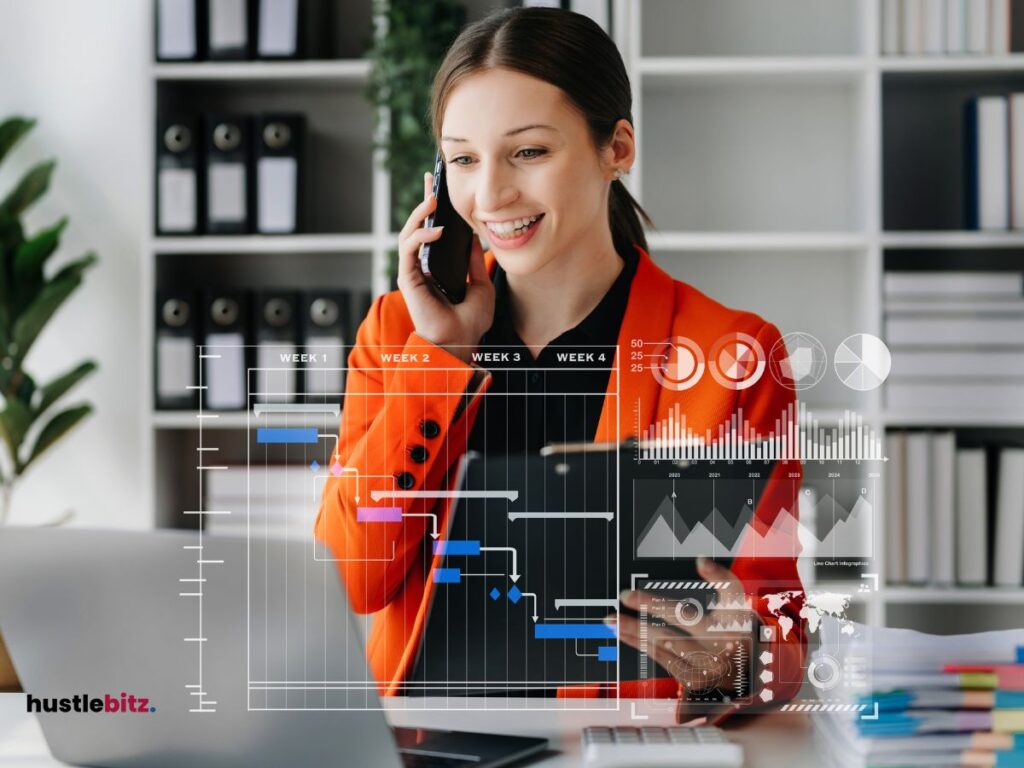 A picture of a woman holding a tablet and using a cellphone inside the office