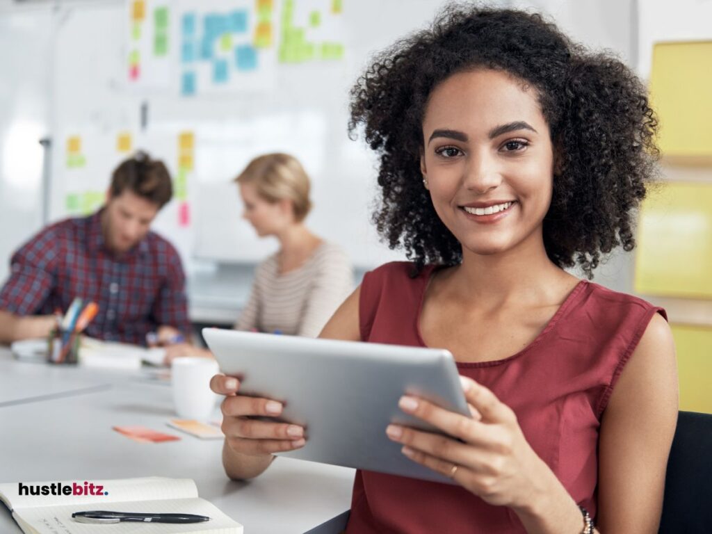 A woman holding a tablet and two people background