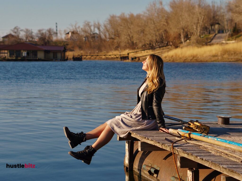 A woman sit beside the river