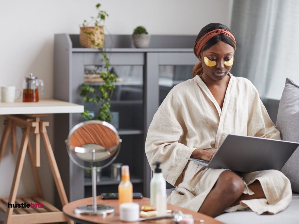 A woman holding a laptop while sitting on the couch