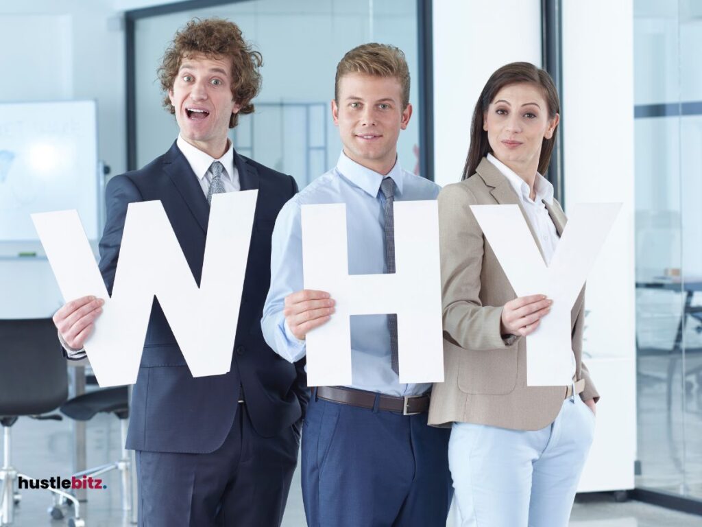 Three people holding a letters inside the office