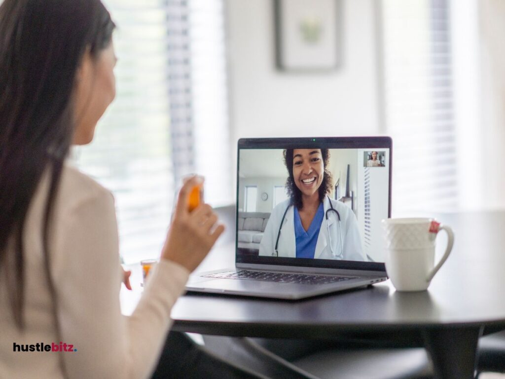 a woman looking at the laptop with another woman