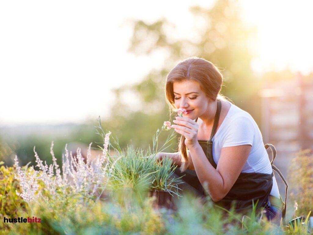 A woman pick a flower and smell it