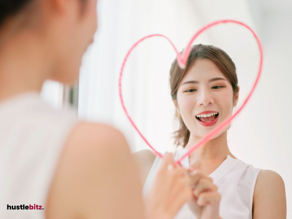 A woman looking at the mirror and draw a heart