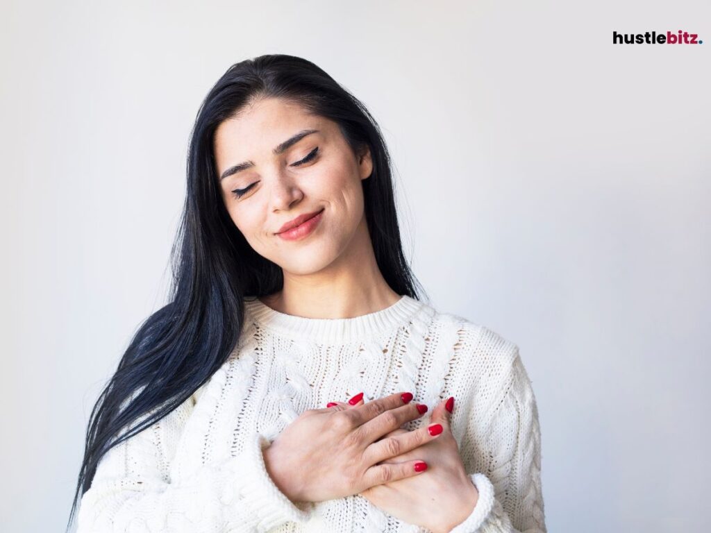 A woman hold her chest and smile