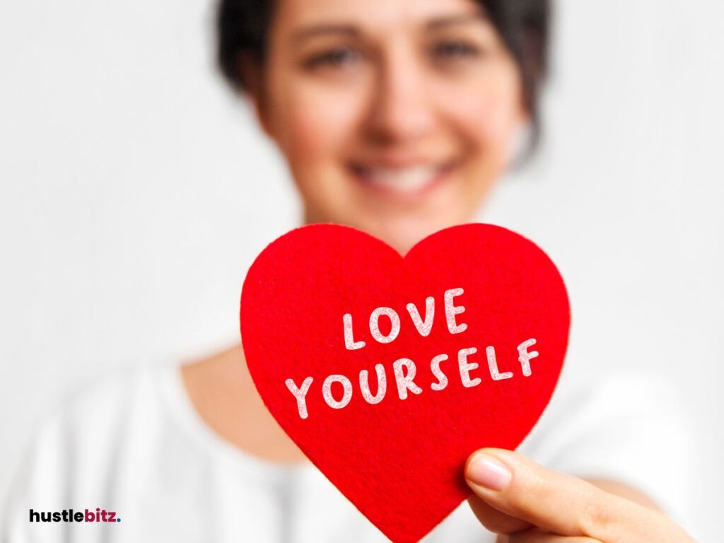 A woman holding a heart with word "love your self"