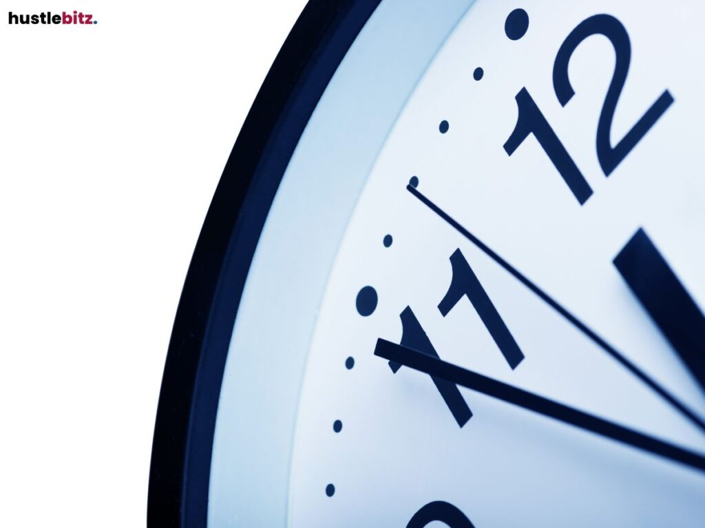Close-up of a clock showing time just before 12 o'clock.