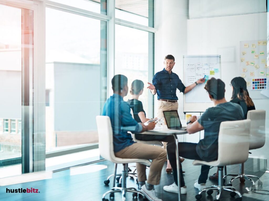 A group of people talking and listening inside the meeting room