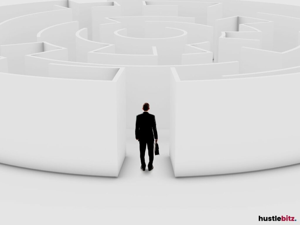 A businessman standing at the entrance of a large, white maze.