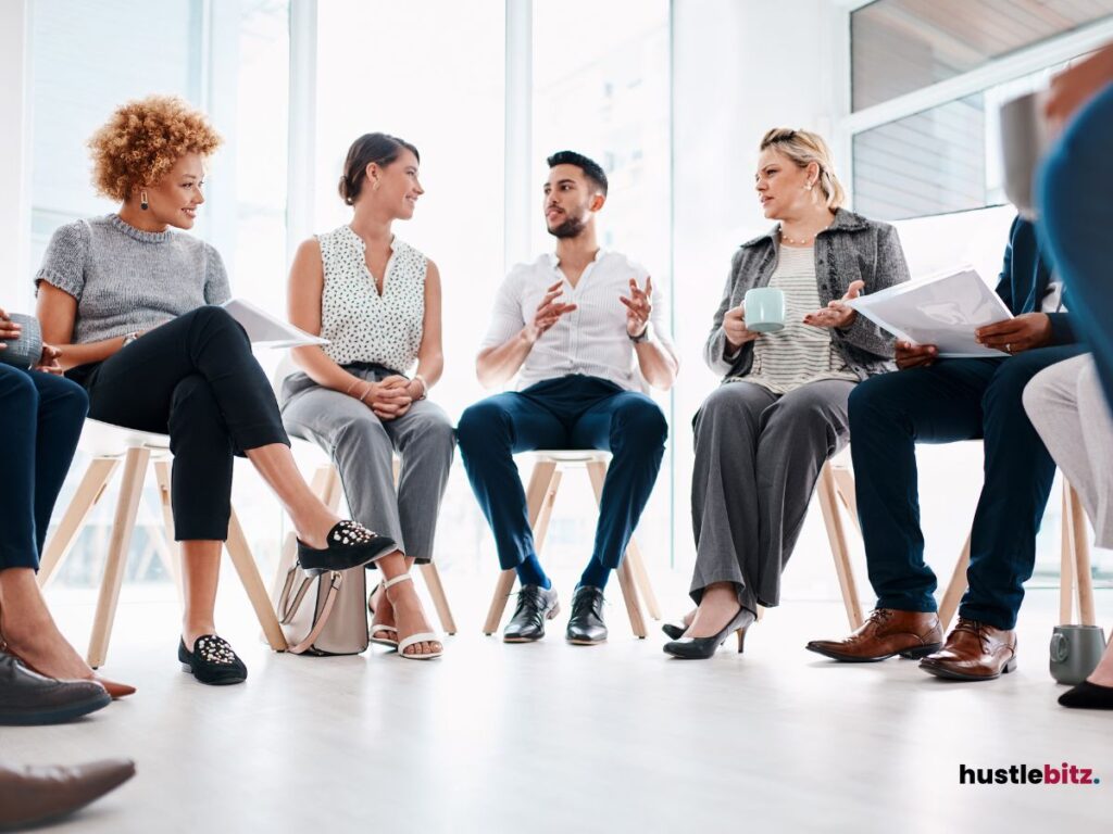 A group of professionals sitting in a circle, actively engaged in discussion and collaboration.