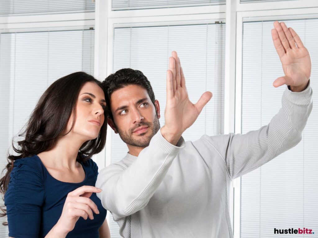 A man and woman visualizing an idea with hand gestures.