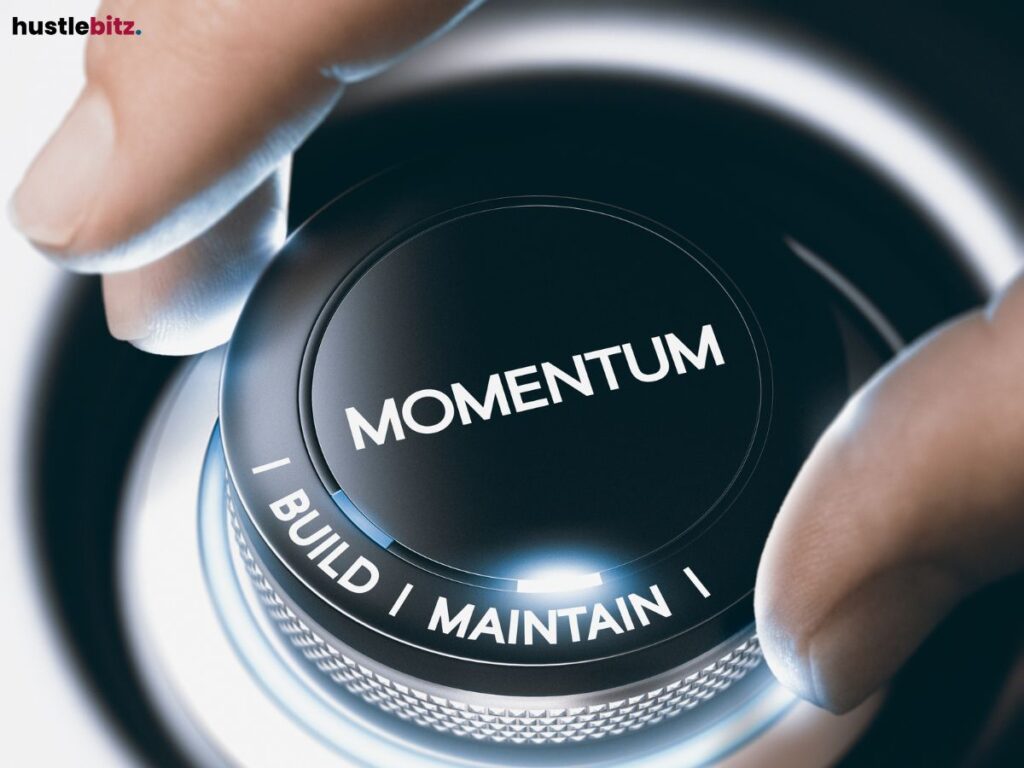  A hand turns a dial marked with "Momentum" and options to build or maintain.