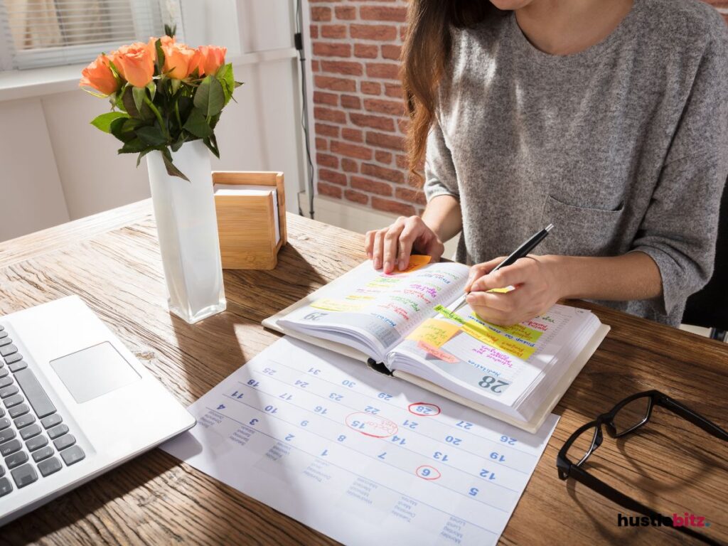 A woman doing writing and a calendar in the tbale