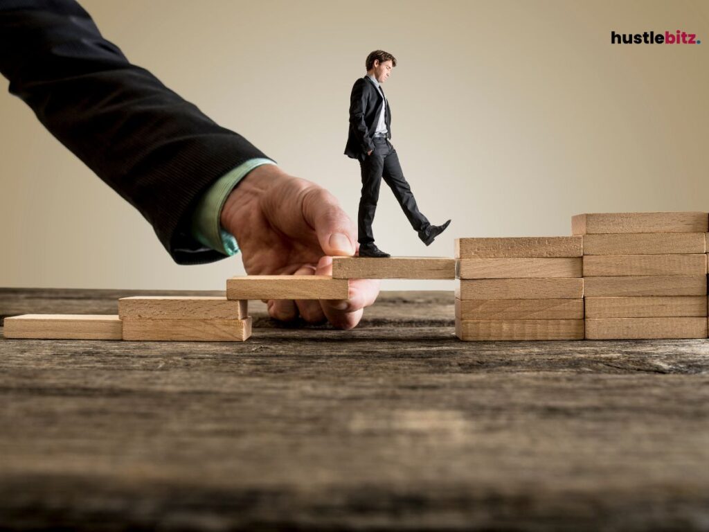 A man walking towards the wooden stairs and a big hand