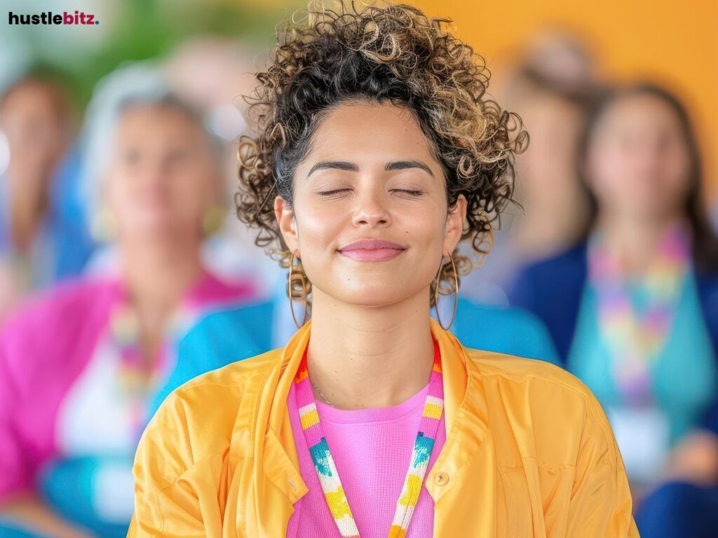 Woman meditating, looking peaceful, with a crowd in the background.