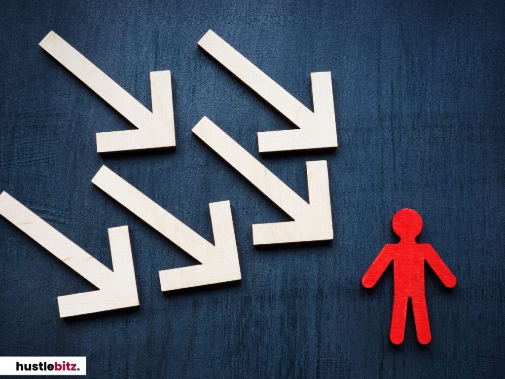 Wooden arrows pointing at a red figure.