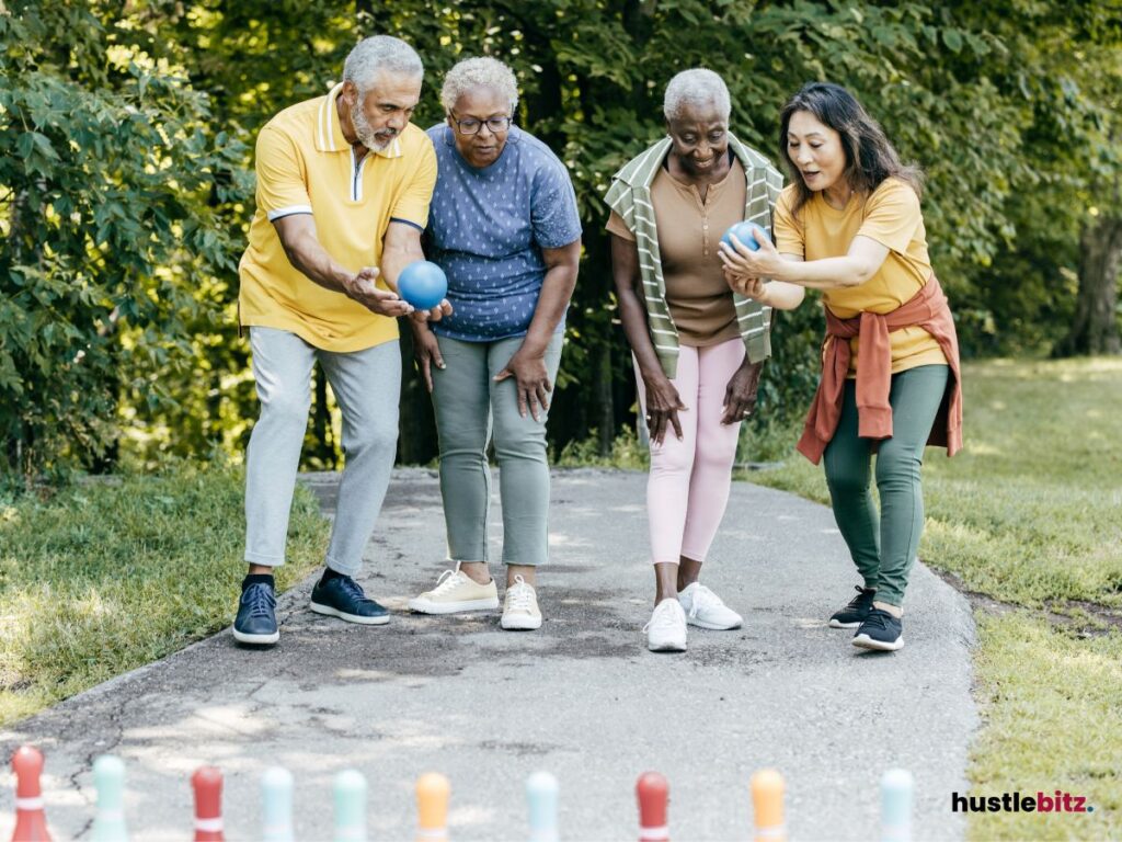 A group of seniors playing a bowling game outdoors.