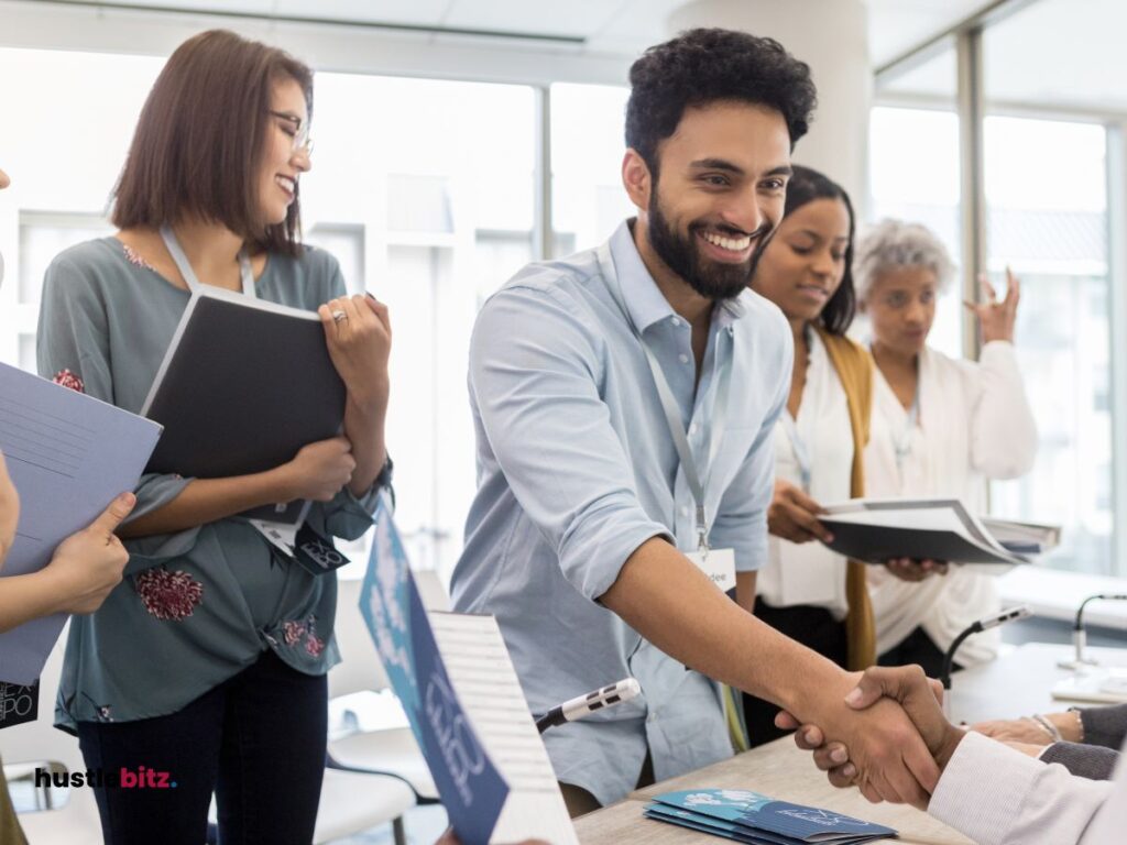 A group of people smiling inside the office