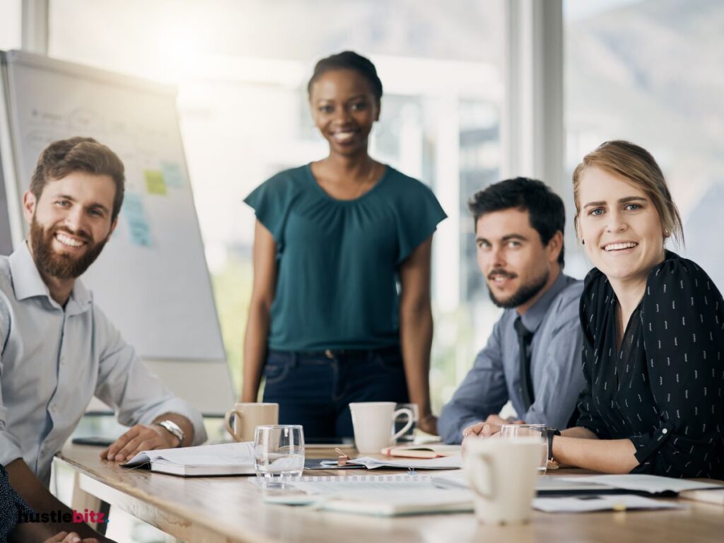 A group of people smiles and looking at the camera
