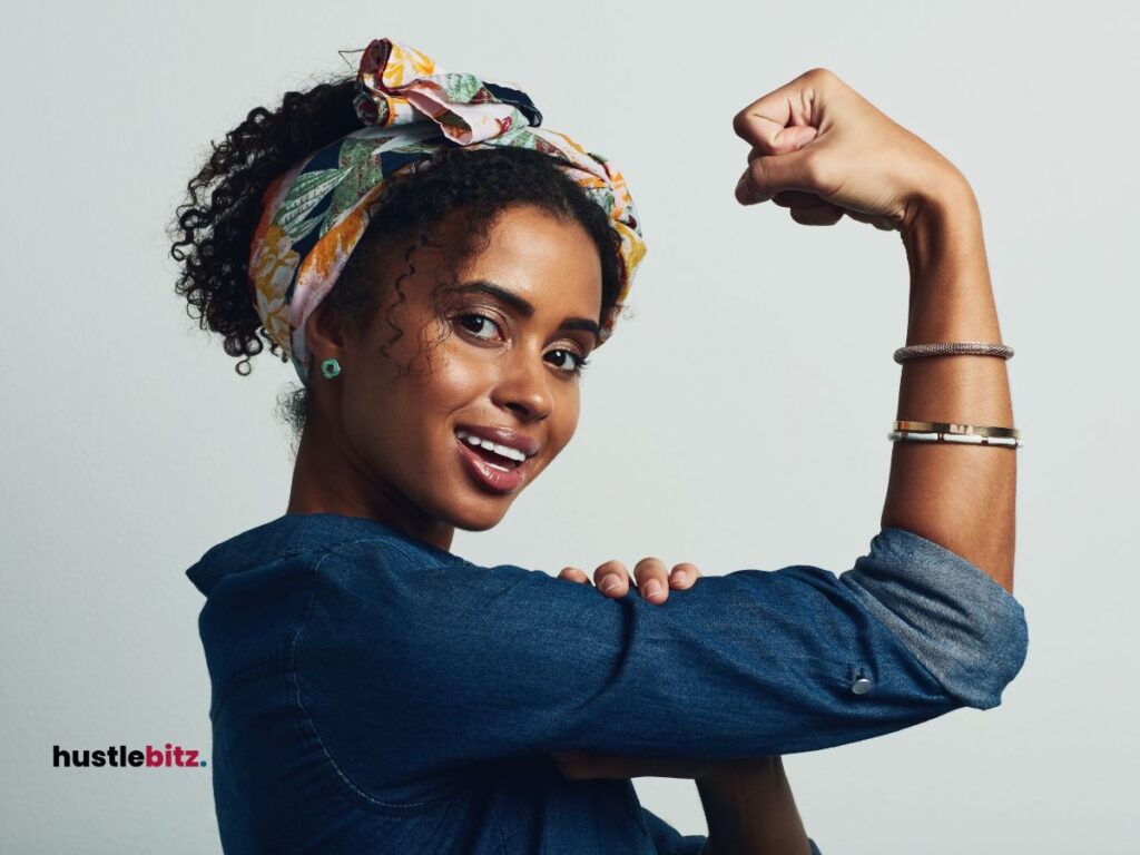 A confident woman flexing her arm in a "strong" pose.