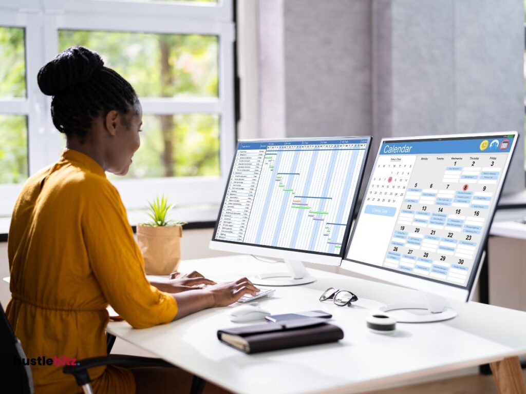 a man facing two monitor and smiles