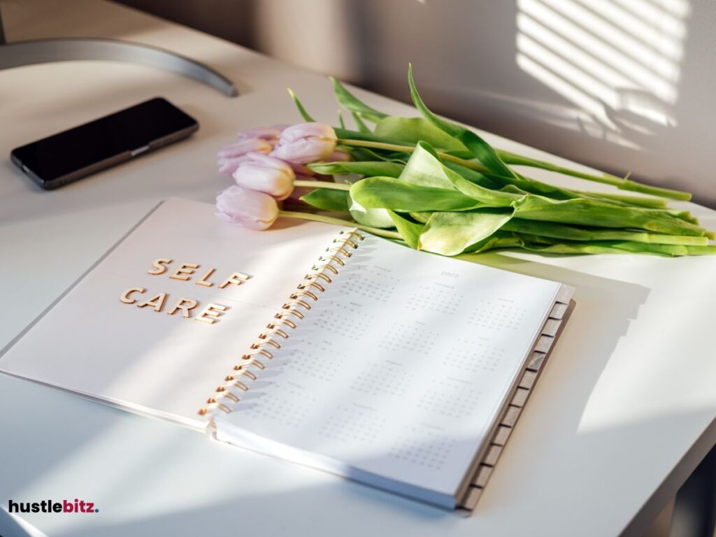 A table with notebook and a flowers