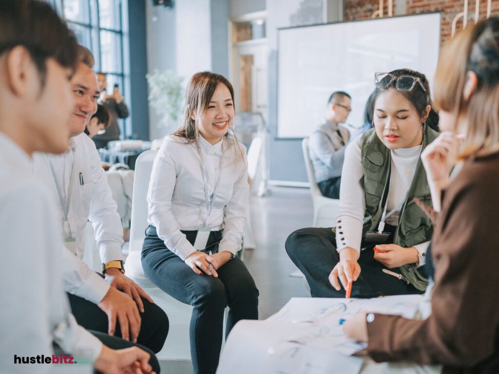 a group of people talking and smiling