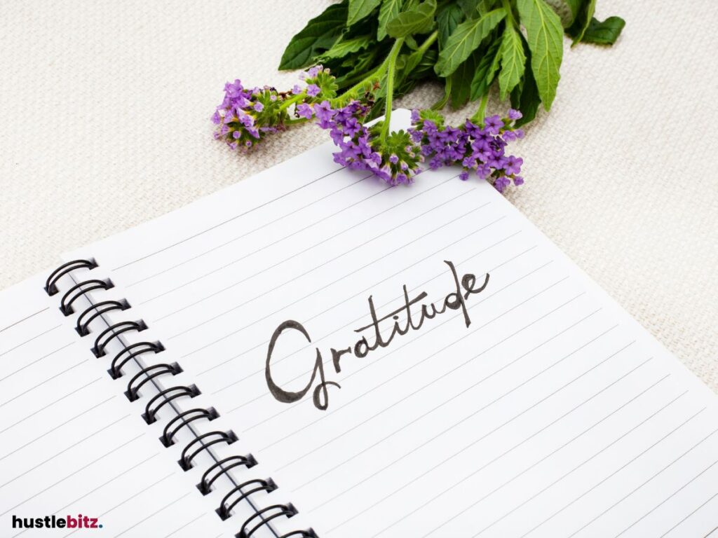 A journal page with the word "Gratitude" written, next to flowers.
